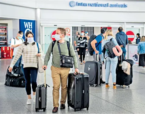  ??  ?? Arrivals at London Stansted Airport yesterday, hours after the Government imposed a two-week quarantine rule for anyone returning from Spain