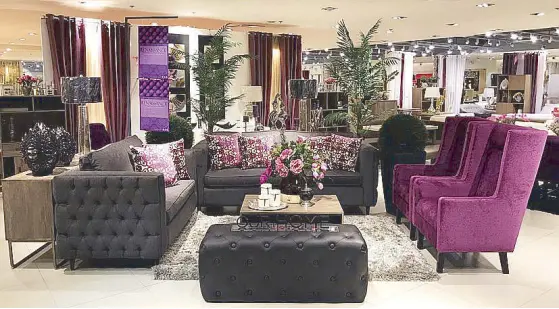  ??  ?? Live it up: This living room vignette sees violet take on a modern-glam vibe as a three-seater and a two-seater sofa in gray tufted fabric set the tone for a living room montage. A pair of wing chairs in deep purple brocade fabric evokes a regal yet...