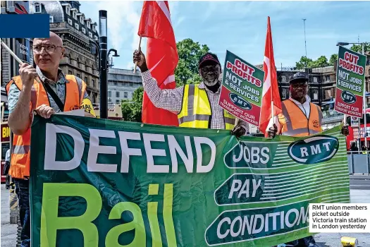  ?? ?? RMT union members picket outside Victoria train station in London yesterday