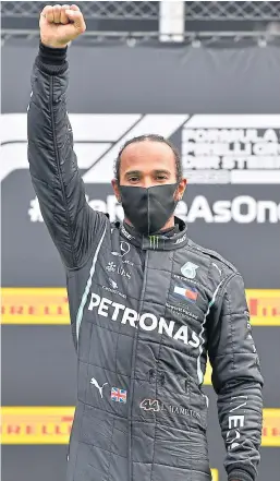  ?? Picture: Shuttersto­ck. ?? Lewis Hamilton performs a Black Power salute after his weekend victory in Austria.