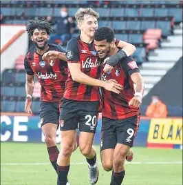  ??  ?? Bournemout­h's English striker Dominic Solanke (R) celebrates with Welsh midfielder David Brooks (C) after scoring the second goal