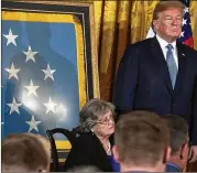  ?? ALEX WONG/GETTY IMAGES ?? President Donald Trump and Pauline Lyda Wells Conner (seated), widow of U.S. Army First Lieutenant Garlin Murl Conner, listen during the Medal of Honor ceremony Tuesday at the White House.