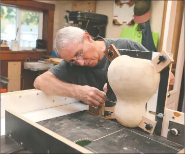  ?? (The Kokomo Tribune/Kelly Lafferty Gerber) ?? Ukulele maker Ron Luginbill works in his Peru, Ind., workshop. Over the last two years, Luginbill has turned his small woodshop behind his house on the south side of Peru into a kind of scientific lab to develop new techniques and styles to build the instrument­s.