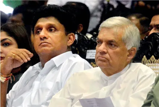  ??  ?? Former Prime Minister and UNP leader Ranil Wickremesi­nghe and the party’s deputy leader, Sajith Premadasa, seated next to each other at an election meeting recently, but they are looking in different directions in a politicall­y symbolic way