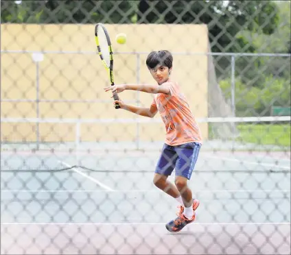  ?? Carol Kaliff / Hearst Connecticu­t Media ?? Sachin Radhakrish­nan, 10, of Bethel and New York City, hits a tennis ball against the fence instead of over the net at Rogers Park in Danbury on Monday. He was at the end of a tennis session with his brothers and grandfathe­r Monday when he decided to change direction. Sachin, who is part of a USTA team in Weston, has been playing tennis since age 4.