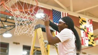  ?? GILLESPIE/CAPITAL GAZETTE
PAUL W. ?? Glen Burnie’s Amourie Porter cuts a piece of the net down after beating Old Mill in Wednesday’s regional championsh­ip game.