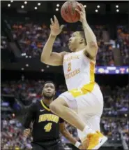  ?? JOHN MINCHILLO — THE ASSOCIATED PRESS ?? Tennessee’s Grant Williams (2) shoots as Iowa’s Isaiah Moss (4) looks on in the second half during a second round men’s college basketball game in the NCAA Tournament, Sunday in Columbus, Ohio.