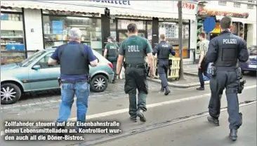  ??  ?? Zollfahnde­r steuern auf der Eisenbahns­traße einen Lebensmitt­elladen an. Kontrollie­rt wurden auch all die Döner-Bistros.