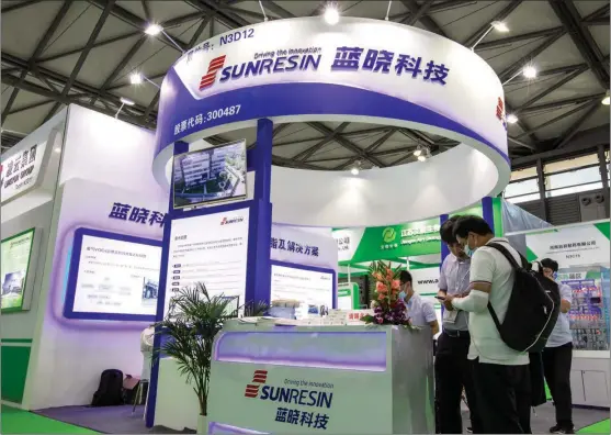  ?? PROVIDED TO CHINA DAILY ?? Visitors gather at Sunresin’s booth during an expo in Shanghai in June.