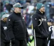  ?? MICHAEL PEREZ — THE ASSOCIATED PRESS ?? Eagles head coach Doug Pederson, left, and Carson Wentz watch warmups before Saturday’s game at the Linc.