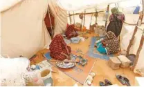  ?? - Reuters ?? STRANDED: Libyan women displaced from the town of Tawergha are seen at a camp in the Garart Al Gatef, Libya on March 25, 2018.