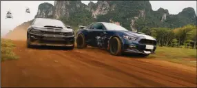  ??  ?? Sibling rivalry: Dom Toretto’s (Vin Diesel) custom-made $1 million Dodge Charger and a highly modified Ford Shelby Mustang GT350 V8 belonging to his nemesis/brother Jakob (John Cena) duel it out in “F9: The Fast Saga.”