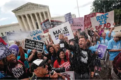  ?? The Associated Press ?? ■ Anti-abortion advocates celebrate outside the Supreme Court in Washington on June 24, 2022, following the court’s decision to end constituti­onal protection­s for abortion that had been in place nearly 50 years. One year ago, the U.S. Supreme Court rescinded a fivedecade-old right to abortion, prompting a seismic shift in debates about politics, values, freedom and fairness.