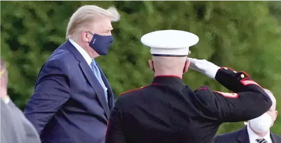  ?? JACQUELYN MARTIN/AP ?? President Donald Trump arrives Friday at Walter Reed National Military Medical Center, in Bethesda, Md., after he tested positive for COVID-19.