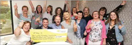  ??  ?? The ‘Lucky Thursday’ Lotto syndicate celebrate their winnings at Lotto HQ on Tuesday.