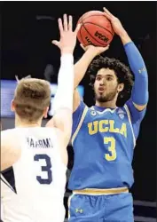  ?? Andy Lyons Getty Images ?? ONE SCOUT SAID Johnny Juzang should try the NBA draft now after his strong tournament play.