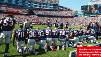  ??  ?? Members of the New England Patriots pointedly kneel for the national anthem before a game in Boston this week. Many teams have adopted the practice, called “taking the knee”. Below: Colin Kaepernick instigated the protests against racial injustice.