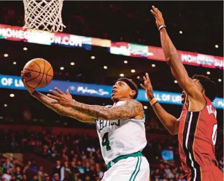  ?? EPA PIC ?? Boston Celtics’ Isaiah Thomas (left) goes for the basket in their NBA game against Miami Heat at TD Garden on Sunday.