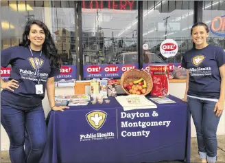  ?? KARA DRISCOLL / STAFF ?? Dayton-Montgomery County Public Health workers Angy El-Khatib (left) and Haley Riegel went out in the community to spread awareness about the Good Food Here Healthy Corner Store initiative.
