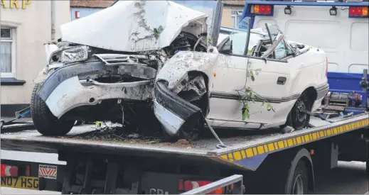  ??  ?? The crashed car is removed after the fatal accident near Sturry crossing