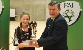  ??  ?? Pixie O’Hara of St. Attracta’s Community School, Tubbercurr­y is presented with the Player of the Tournament award by FAI president Donal Conway.