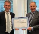  ?? ?? WAIFC Managing Director Jochen Biedermann presenting FinanceMal­ta’s membership certificat­e to Ivan Grech, CEO of the Institute of Financial Services Practition­ers (IFSP)