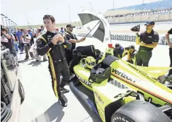  ??  ?? Simon Pagenaud stands next to his car during Friday’s qualifying for Saturday’s IndyCar Series race at Iowa Speedway in Newton, Iowa. AP