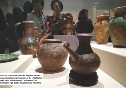  ??  ?? VISITORS look at some ewers and kendi with moulded dragon designs during the opening of the exhibit Fujian Ware Found in the Philippine­s (Song-Yuan 11th-14th Century) on Sept. 4 at the Ayala Museum in Makati City.