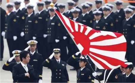  ??  ?? Japan’s Prime Minister Shinzo Abe (l) reviewing members of Japan Self-Defense Force (JSDF) during the JSDF Air Review, to celebrate 60 years since the service’s founding, at Hyakuri air base in Omitama, northeast of Tokyo...recently