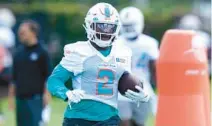  ?? LYNNE SLADKY/AP ?? Dolphins running back Chase Edmonds takes part in drills Wednesday at the team’s practice facility in Miami Gardens.