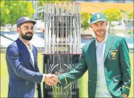  ?? BCCI ?? Skippers Virat Kohli and Faf du Plessis unveil the Freedom Series trophy in Cape Town.