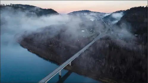  ?? ?? In this aerial image taken from a drone, the city of Klamath, Calif., home of the tribal headquarte­rs for the Yurok Tribe, is seen Jan. 21 on the side of U.S. 101 at sunrise.
