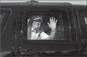  ?? The Associated Press ?? EN ROUTE: President Donald Trump waves to supporters from his motorcade traveling en route to his Mar-a-Lago estate from Trump Internatio­nal Golf Club on Thursday in West Palm Beach, Fla.