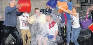  ??  ?? Leading by example Fraser Heggie, leader of the Criss-Cross Youth Group, getting his soaking. Among Fraser’s nomination­s were Drummond McNicol and May Paton - his grandmothe­r