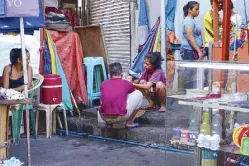  ??  ?? Tiangge stall holders virtually live on the street beside the plaza.