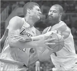  ?? Ross D. Franklin Associated Press ?? LAKERS CENTER Brook Lopez, left, grimaces as he’s fouled by Phoenix Suns center Tyson Chandler while going up for a shot. Lopez scored 15 points.