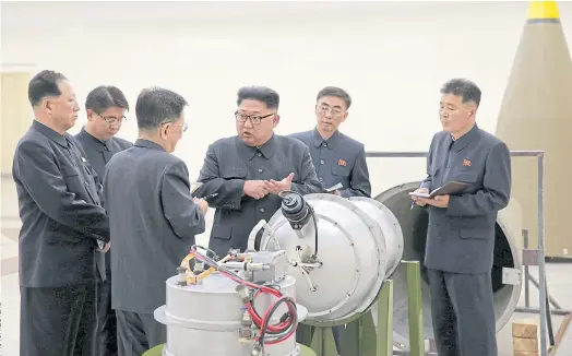  ??  ?? I WANT A BIG BUTTON: North Korean leader Kim Jong Un provides guidance on a nuclear weapons programme.