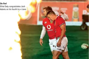  ??  ?? On fire!
Elliot Daly congratula­tes Josh Adams on his fourth try v Lions