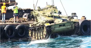  ??  ?? Environmen­tal activists drop off old battle tanks provided by the Lebanese Armed Forces into the Mediterran­ean Sea, about three kilometres off the coast of the southern Lebanese port city of Sidon to create new habitat for marine life. — AFP photo