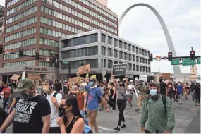  ?? GETTY IMAGES ?? Protesters demonstrat­e against police brutality and the death of George Floyd through downtown St. Louis on Monday. Amid the protests in St. Louis, a man reportedly died after being dragged by a Fedex truck. Fedex officials expressed concern after the fatality.