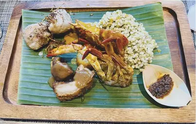  ?? ?? The mini-Boodle served in banana leaves containing Lechon, Piyanggang Manok, Seafood Kare-Kare, and Adlay Rice