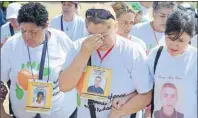  ?? AP PHOTO ?? Relatives and families of missing people arrive a ceremony to remember the missing and kick off a search effort in La Escombrera, on the outskirts of Medellin, Colombia, Monday. La Escombrera is a landfill where the remains of as many as 300 people are...