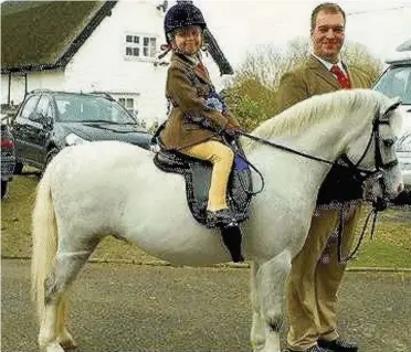  ??  ?? Reuben the pony died after a suspected arson attack at his stables in Marple. He is pictured with owner Asa Howard and his sister Emily, 6