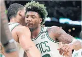  ?? STEVEN SENNE THE ASSOCIATED PRESS ?? Marcus Smart, right, celebrates with Celtics teammate Grant Williams on Sunday in Boston.