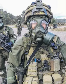  ?? CORPORAL VALERIE CÔTÉ / LAND TASK FORCE MEMBER ?? A Canadian soldier participat­es in chemical, biological, radioactiv­e, and nuclear decontamin­ation exercises with other NATO forces in Kadaga, Latvia, in 2015.