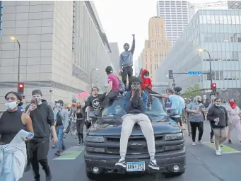  ?? Julio Cortez, The Associated Press ?? The tensions in Minneapoli­s reflected a growing frustratio­n around the country, as demonstrat­ors took to the streets again Friday to protest the death of George Floyd and other black men and women.