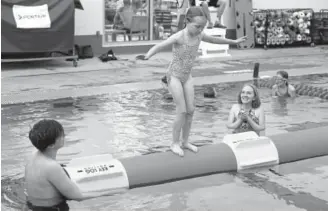  ?? Helen H. Richardson, The Denver Post ?? Katie Heppe cheers on her daughter Claire, 6, as she tries log rolling for her very first time Sunday at the Carla Madison Recreation Center.