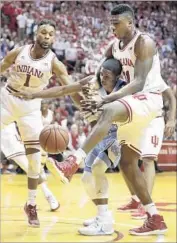  ?? Darron Cummings Associated Press ?? INDIANA’S Thomas Bryant is all over North Carolina’s Kenny Williams as they go for a loose ball.
