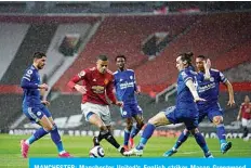  ?? —AFP ?? MANCHESTER: Manchester United’s English striker Mason Greenwood (center) maneuvers through defenders on his way to scoring his team’s opening goal during the English Premier League football match between Manchester United and Leicester City at Old Trafford in Manchester, north west England, on Tuesday.