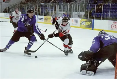  ?? KEVIN ADSHADE/THE NEWS ?? Benji Curtis (63) battles for a loose puck in front of the Amherst goal.